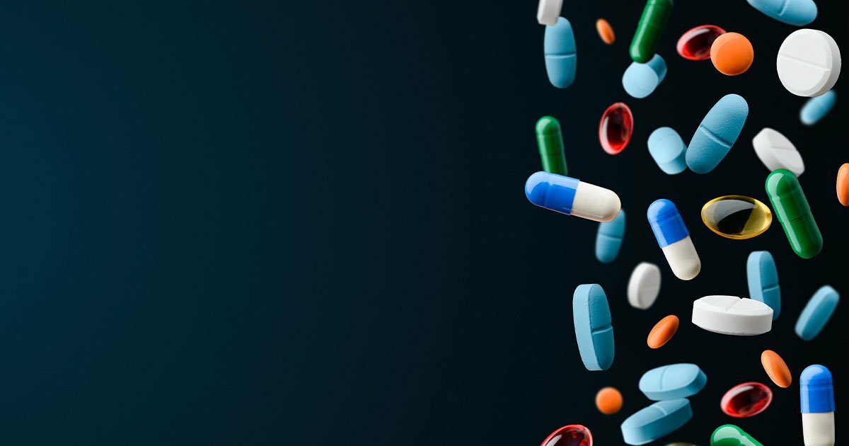 Dark background with pills falling on the right side
