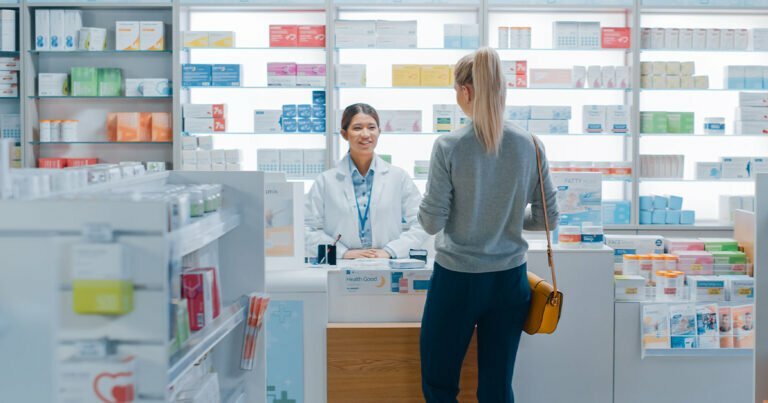 Pharmacist attending to customer in pharmacy