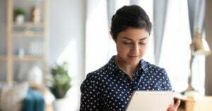 Business lady happy looking at her ipad