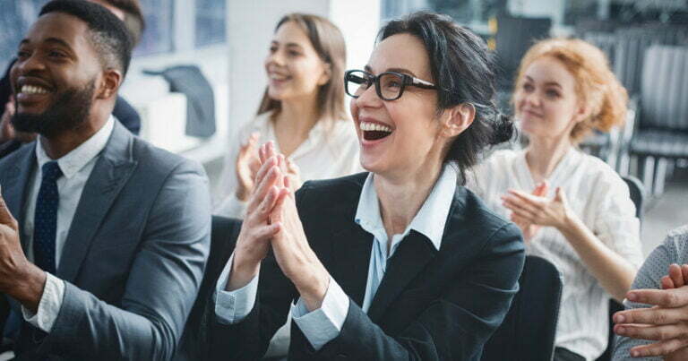 Happy business people clapping and smiling