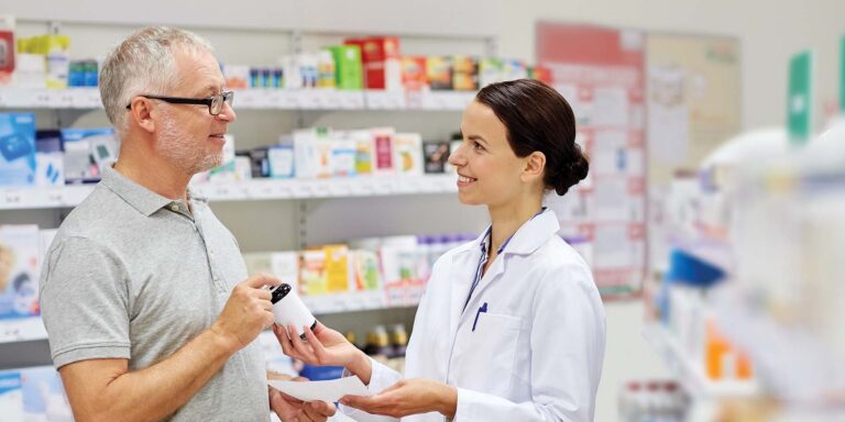 happy pharmacist helping customer
