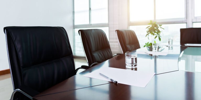 An empty board room meeting table