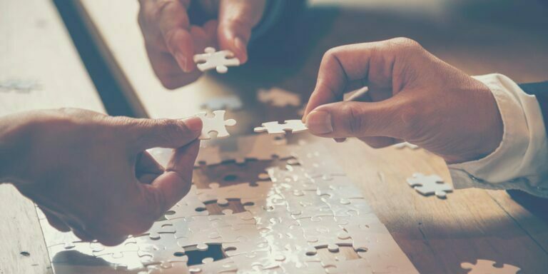 Photo of people putting a puzzle together