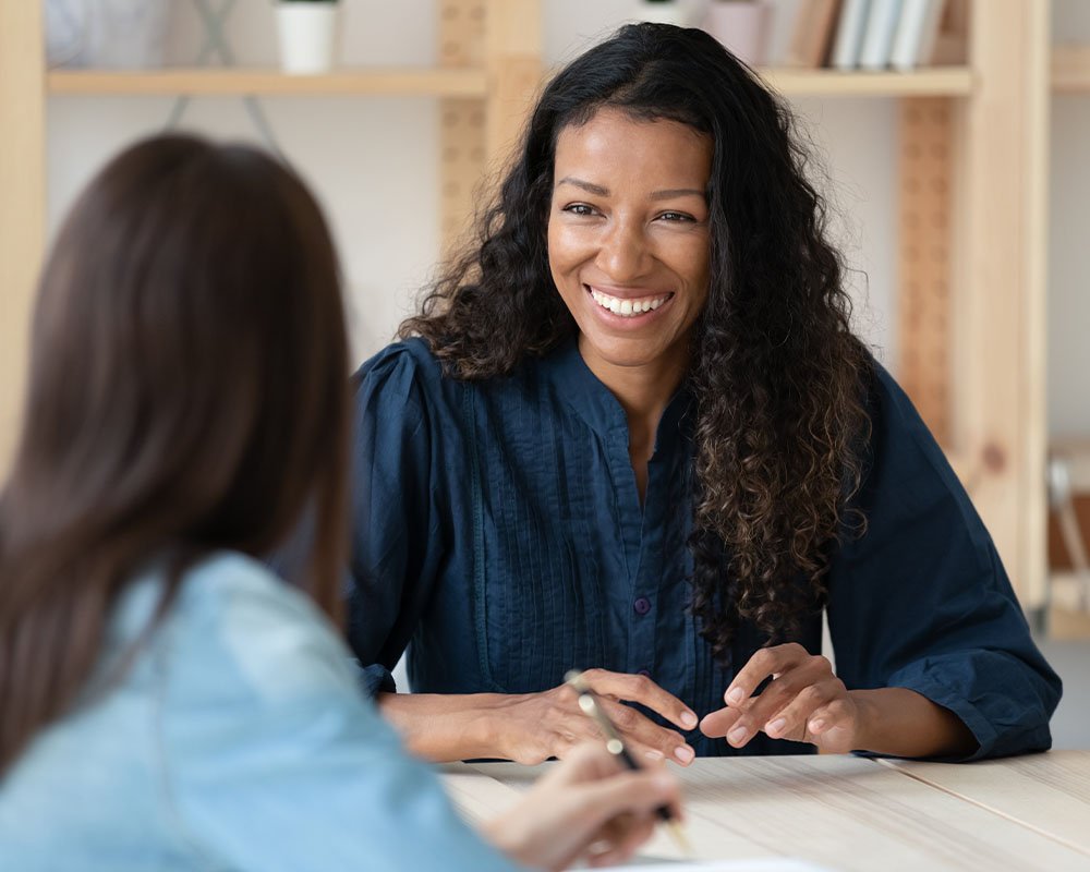 Happy lady talking with coworker