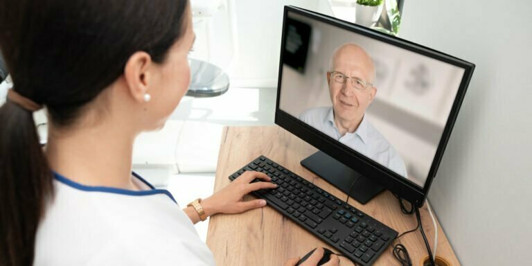 Doctor speaking to patient via computer