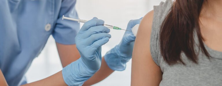 A person getting a shot in the shoulder