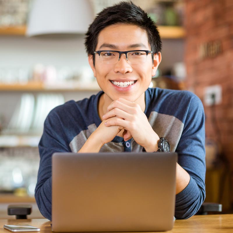 man using laptop smiling