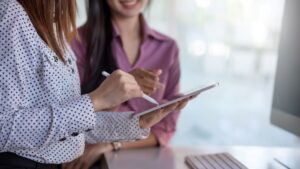 Business people reviewing information on handheld device