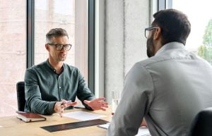 A business person assisting an individual