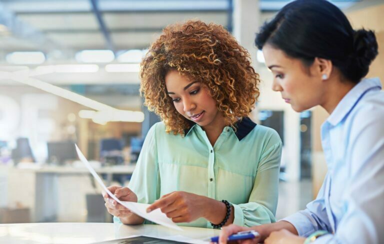 Two business people reviewing paperwork