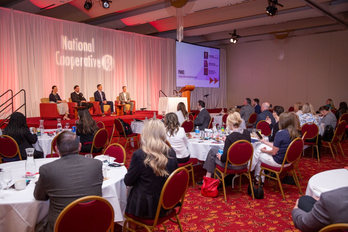 Four annual meeting panelists on stage