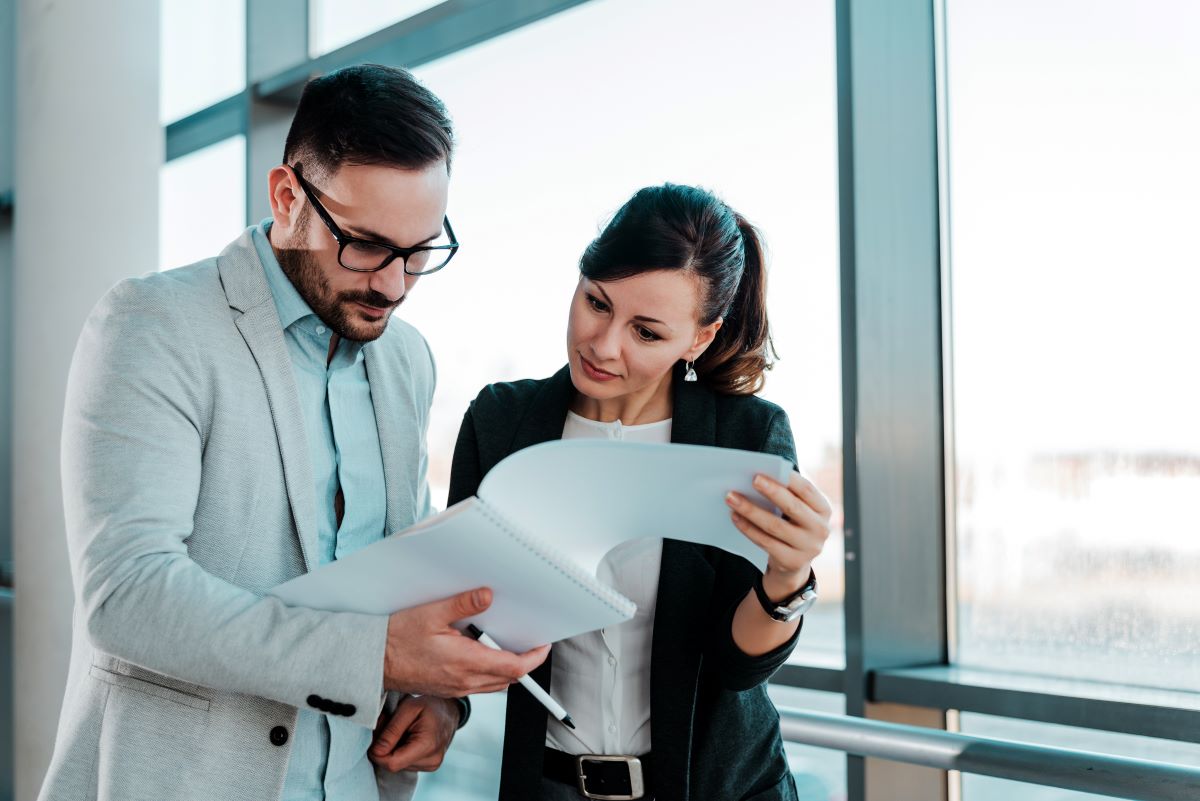 Two business people reviewing paperwork